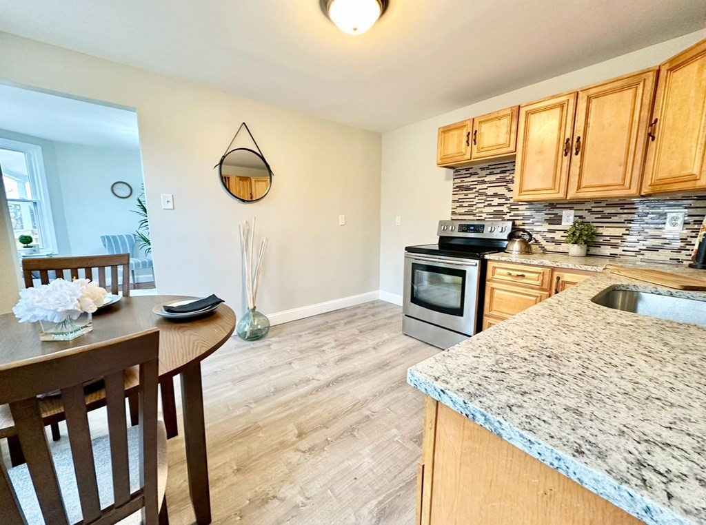 28-30 Kendall Street Springfield, MA 01104 - Photo 10 of 10 a kitchen with a stove a sink and a refrigerator