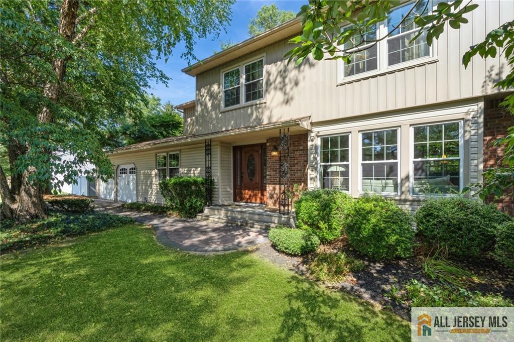 a view of a house with a yard and plants