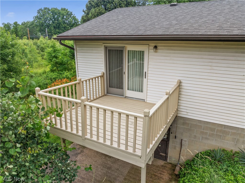 1835 Lynn Road Kent, OH 44240 - Photo 43 of 48 Exterior deck featuring composite decking, matching railings, and a sliding glass door with an integrated screen