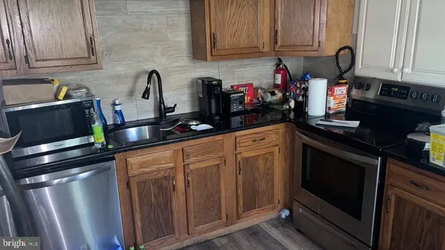 a kitchen with stainless steel appliances granite countertop a stove and cabinets