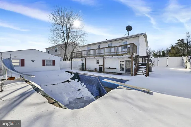 a view of a house with backyard and snow