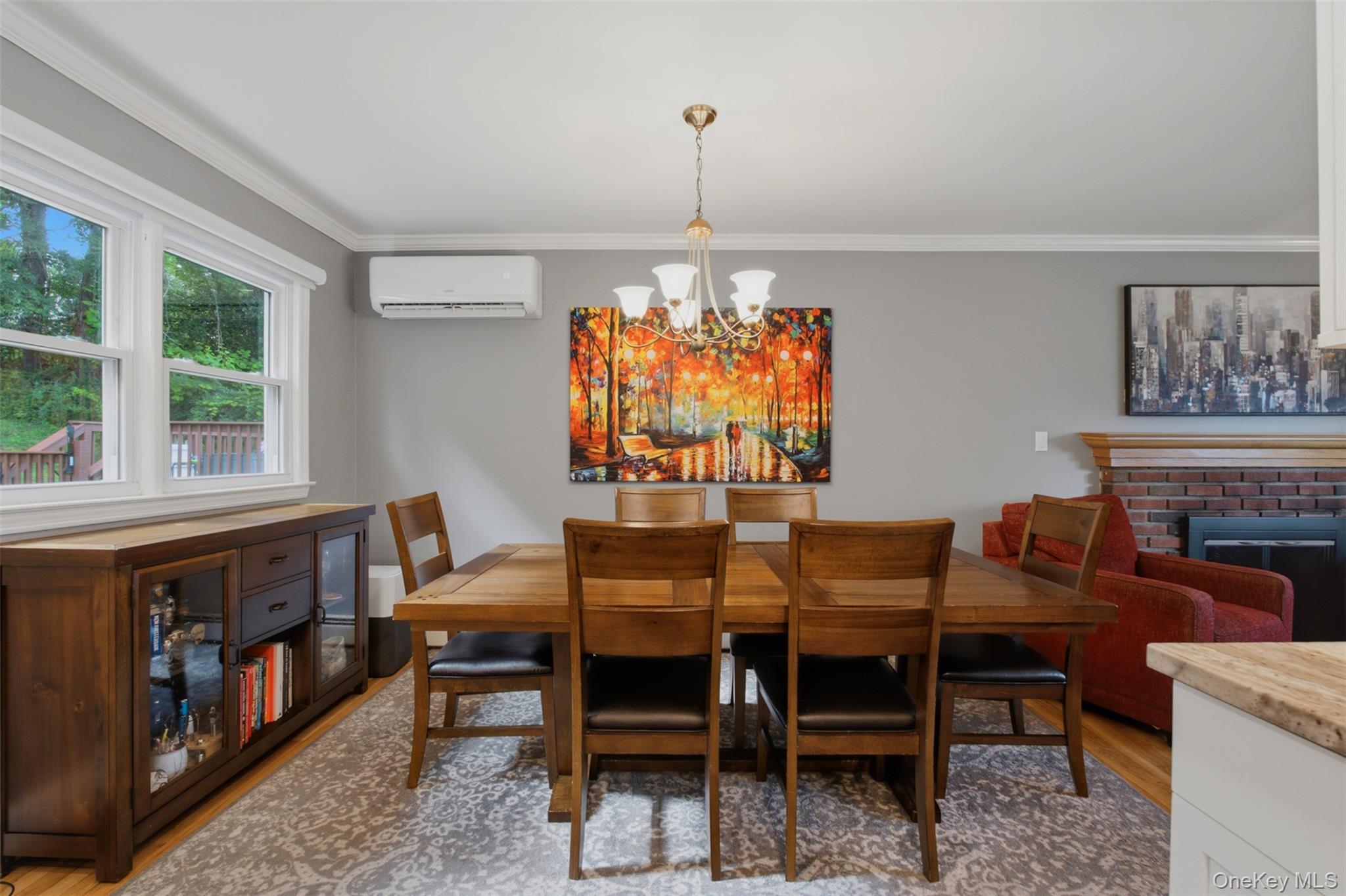 617 Cardinal Road Cortlandt Manor, NY 10567 - Photo 12 of 32 Bright dining area featuring hardwood flooring, crown molding, and a chandelier