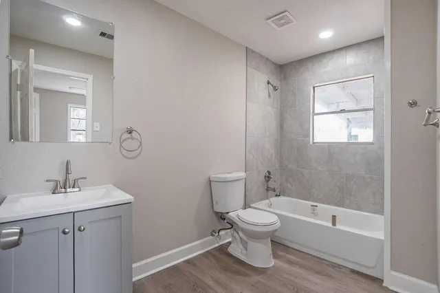 a bathroom with a toilet sink and bathtub