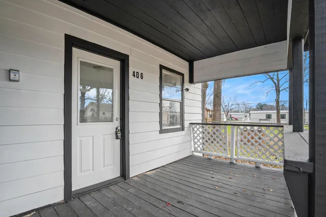 a view of a porch with wooden floor and outdoor space