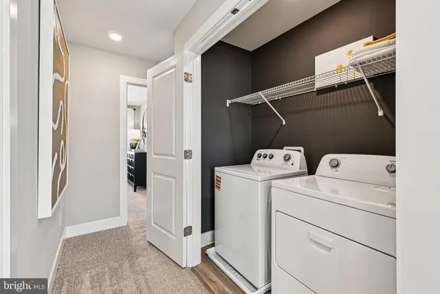 a view of storage and utility room with washer and dryer