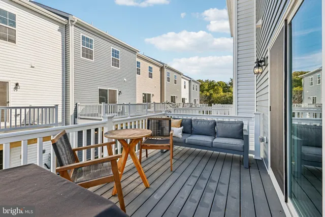 a balcony with furniture and a wooden floor