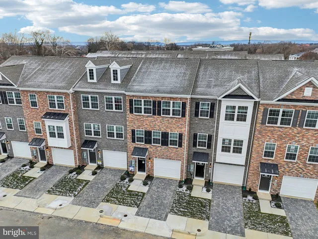a front view of a residential apartment building with a yard