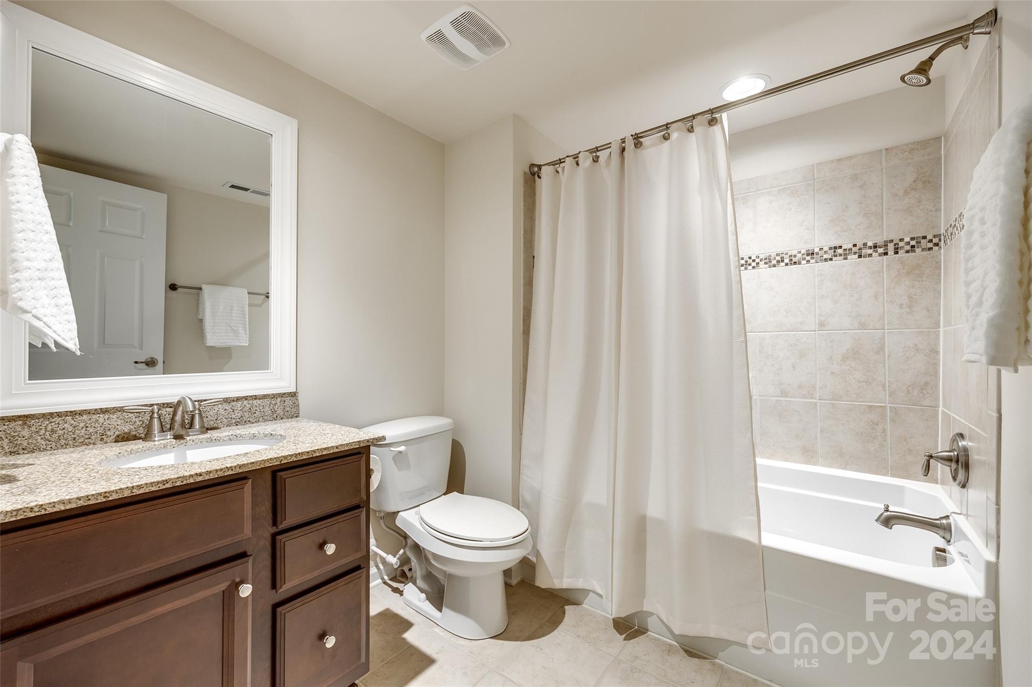 127 Inlet Point Drive Fort Mill, SC 29708 - Photo 27 of 46 a bathroom with a granite countertop sink toilet and shower