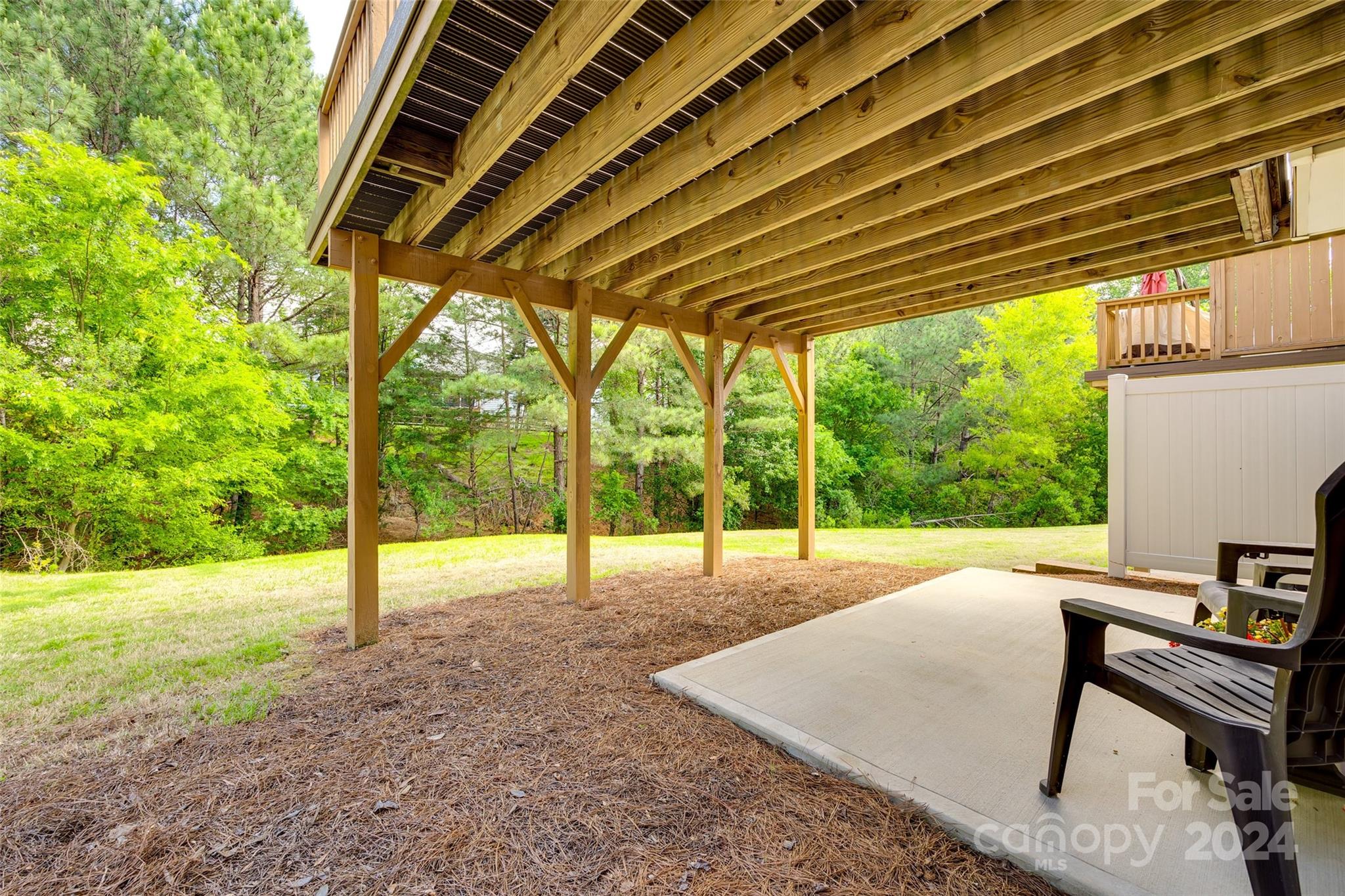 127 Inlet Point Drive Fort Mill, SC 29708 - Photo 31 of 46 a view of a backyard with floor to ceiling windows and wooden roof