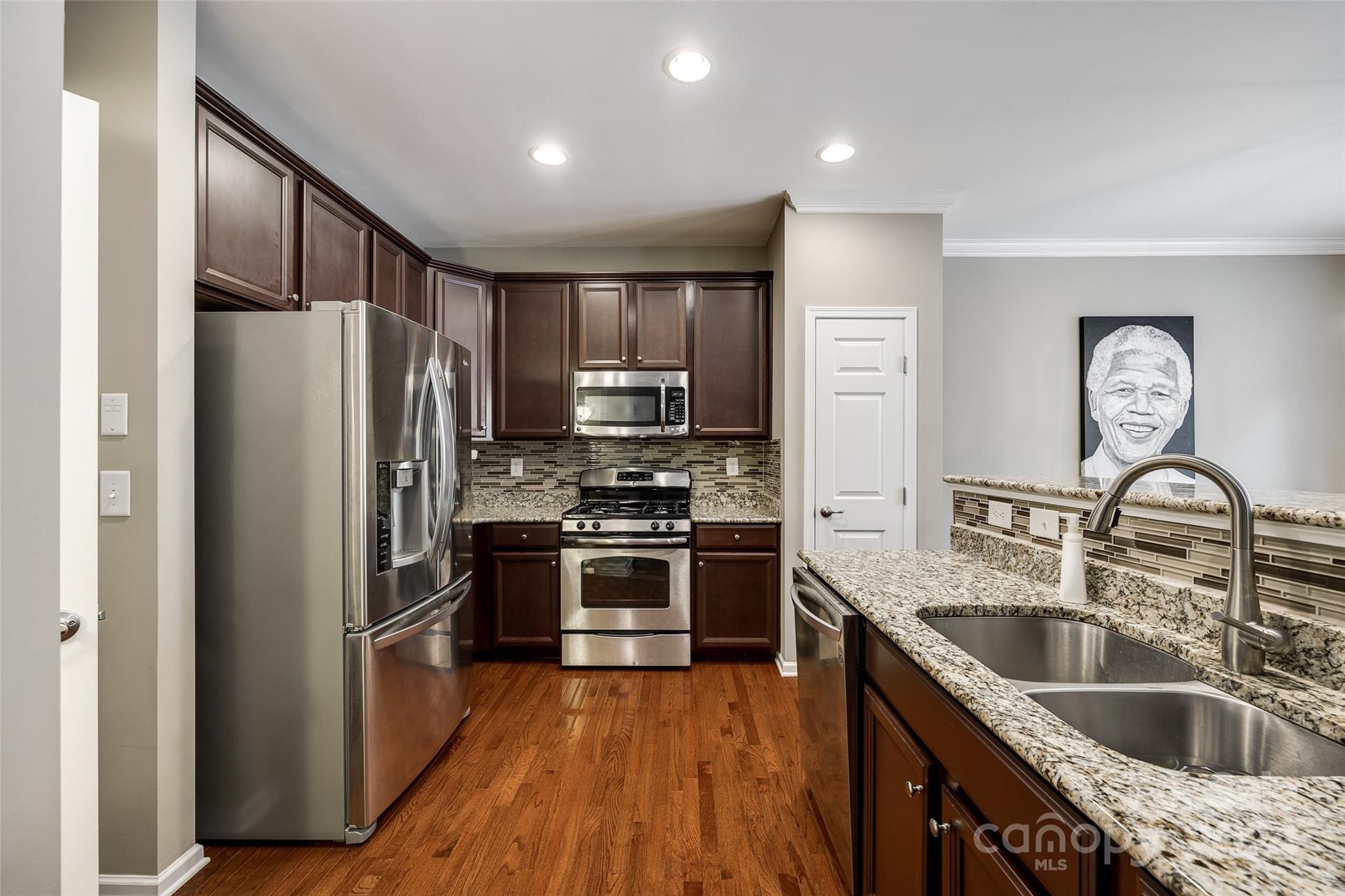 127 Inlet Point Drive Fort Mill, SC 29708 - Photo 8 of 46 a kitchen with kitchen island stainless steel appliances cabinets a sink and a refrigerator