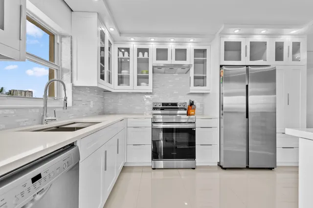 a kitchen with stainless steel appliances granite countertop a stove and a sink