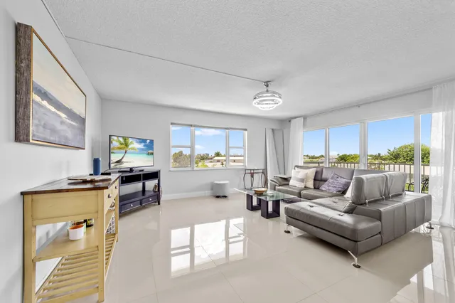 a living room with furniture and a kitchen view
