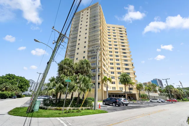an aerial view of a house with a yard and lake view in back
