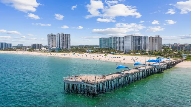 a swimming pool with outdoor seating and yard