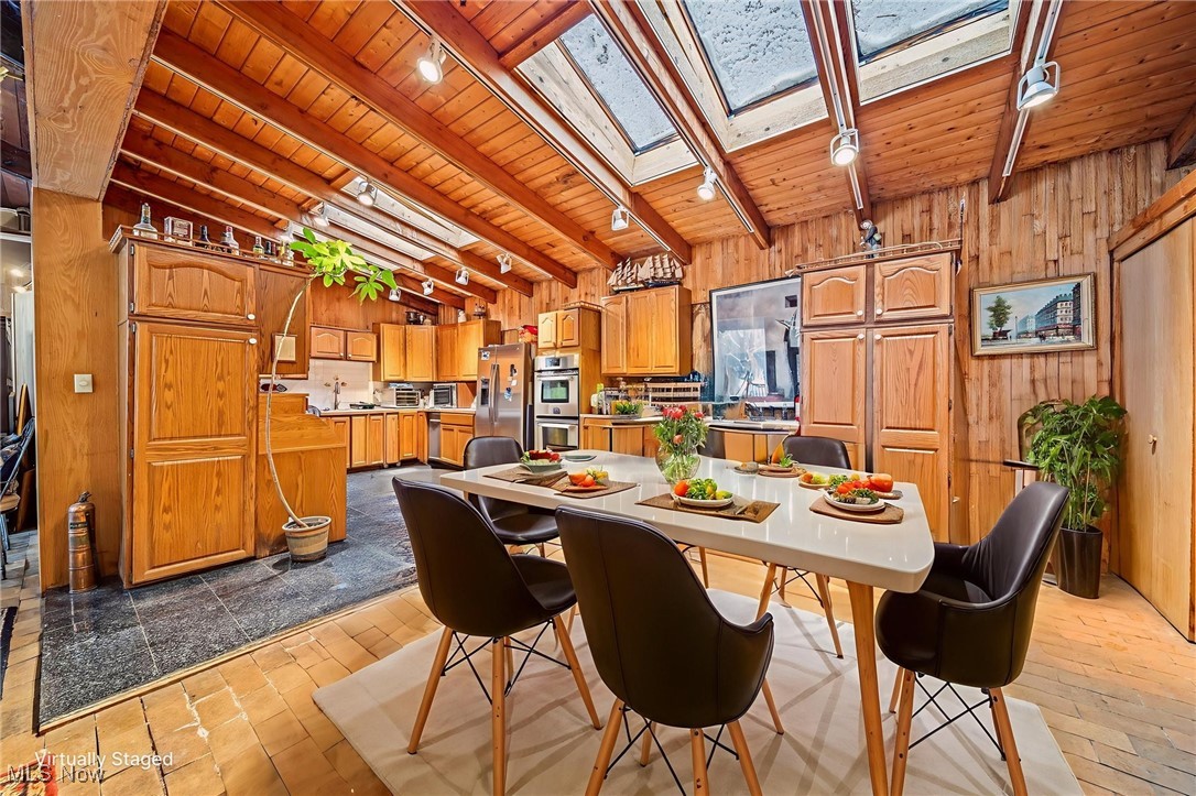 13610 Sperry Road Novelty, OH 44072 - Photo 5 of 42 Dining area with track lighting, skylights and wood detail. (Staged photo)