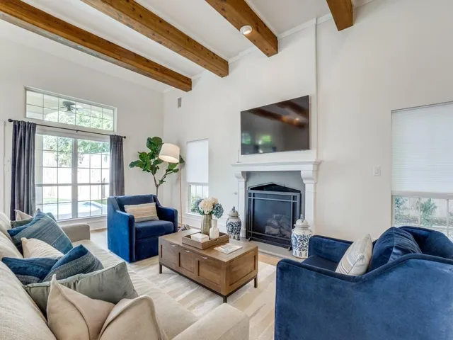 a living room with furniture fireplace and flat screen tv