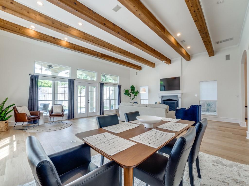 5305 Southern Avenue Dallas, TX 75209 - Photo 19 of 39 a view of a dining room and livingroom with furniture wooden floor a rug a flat screen tv a rug and a chandelier