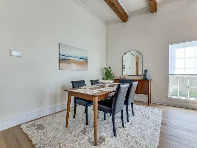 a dining room with furniture and wooden floor