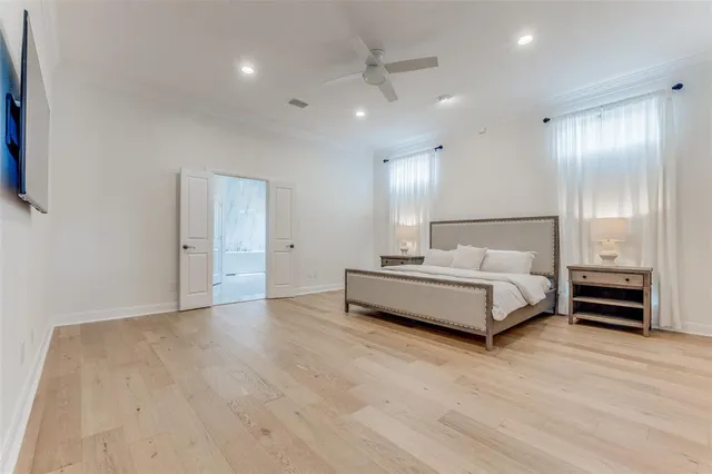 a spacious bedroom with a bed and a view of bathroom