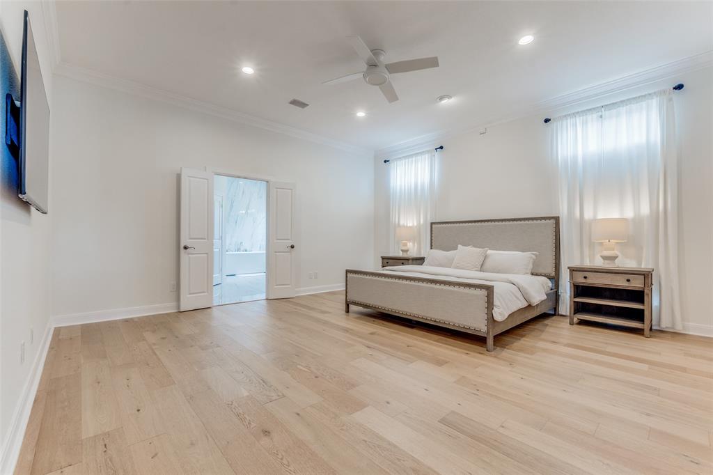 5305 Southern Avenue Dallas, TX 75209 - Photo 23 of 39 a spacious bedroom with a bed and a view of bathroom