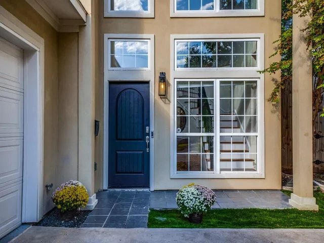 a front view of a house with a garden