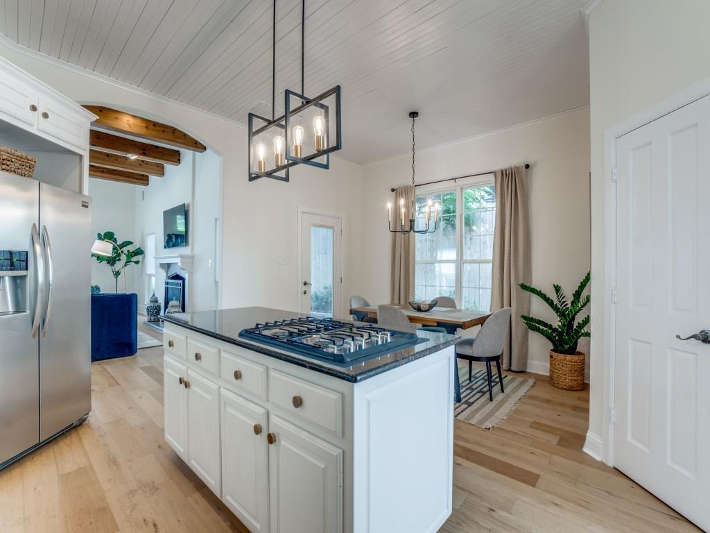 5305 Southern Avenue Dallas, TX 75209 - Photo 9 of 39 a kitchen with stainless steel appliances granite countertop a stove a refrigerator and a wooden floor