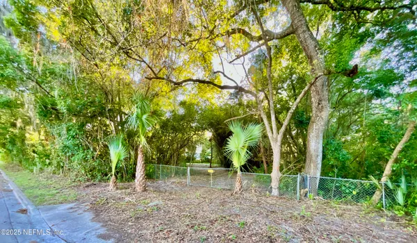 a backyard of a house with lots of trees