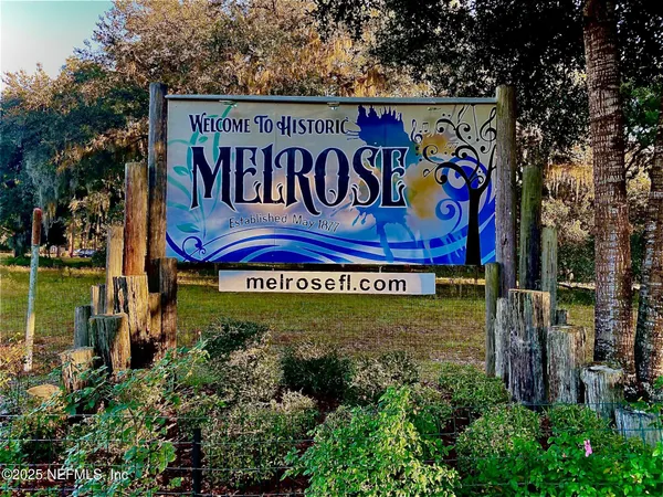 a sign broad in front of flowers