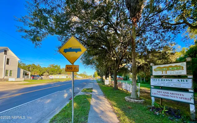 a sign board with a yard and plants