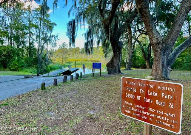 a view of an outdoor space with a garden and trees