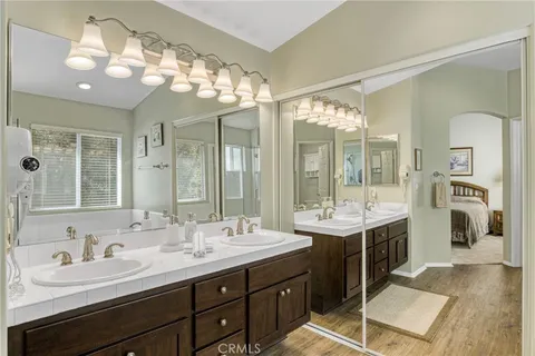 a bathroom with a double vanity sink and a mirror