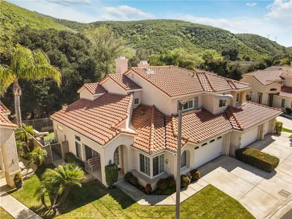 an aerial view of a house with a yard