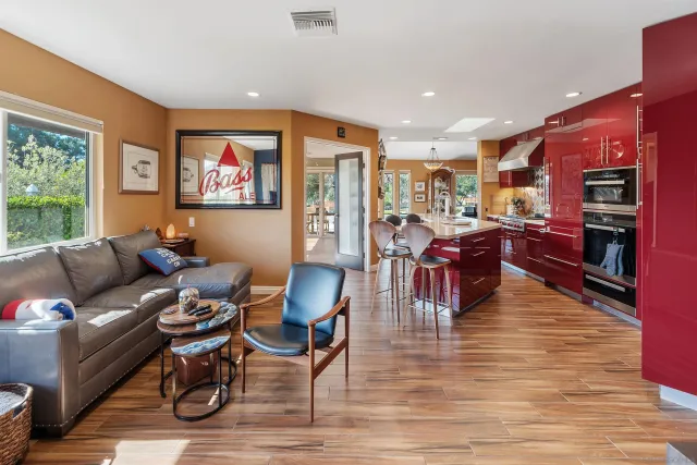a living room with lots of furniture and kitchen view