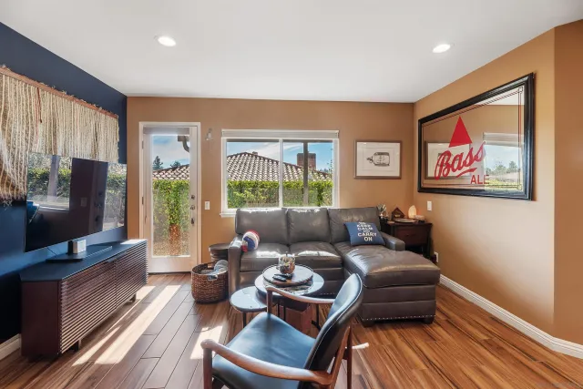 a living room with furniture a large window and a flat screen tv