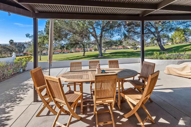 a patio with yard glass top table and chairs
