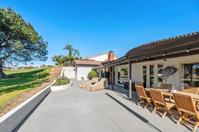 a view of a patio with a table and chairs