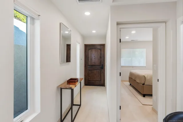a hallway with furniture and a wooden door