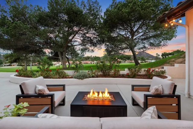 an outdoor sitting area with furniture and a yard