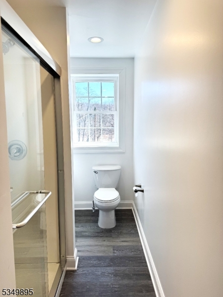 100 Stoll Street, Unit 2 Netcong, NJ 07857 - Photo 4 of 9 a bathroom with a toilet sink a mirror and a shower