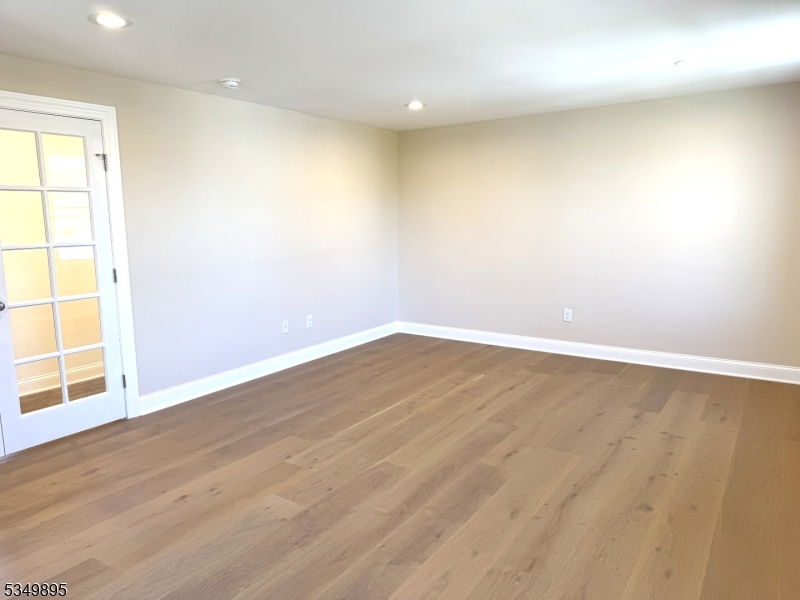 100 Stoll Street, Unit 2 Netcong, NJ 07857 - Photo 8 of 9 an empty room with wooden floor and windows