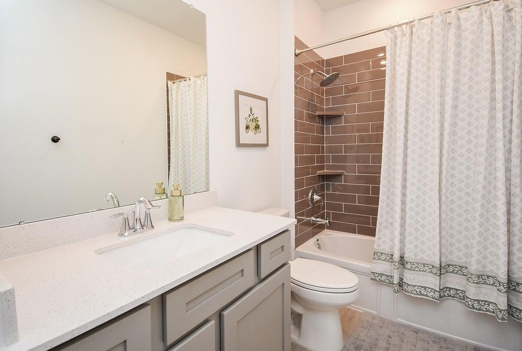 5618 Amber Brook Lane Fulshear, TX 77441 - Photo 15 of 17 a bathroom with a sink a toilet and shower