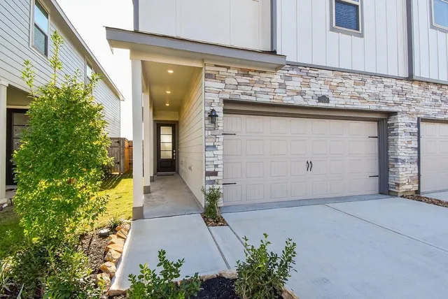 a view of a pathway of house with potted plants