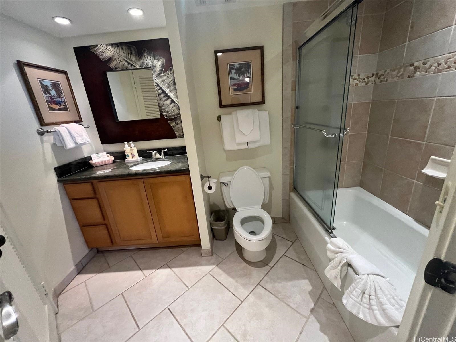 3445 Lower Honoapiilani Road, Unit 212 Lahaina, HI 96761 - Photo 2 of 39 a bathroom with a toilet sink and mirror