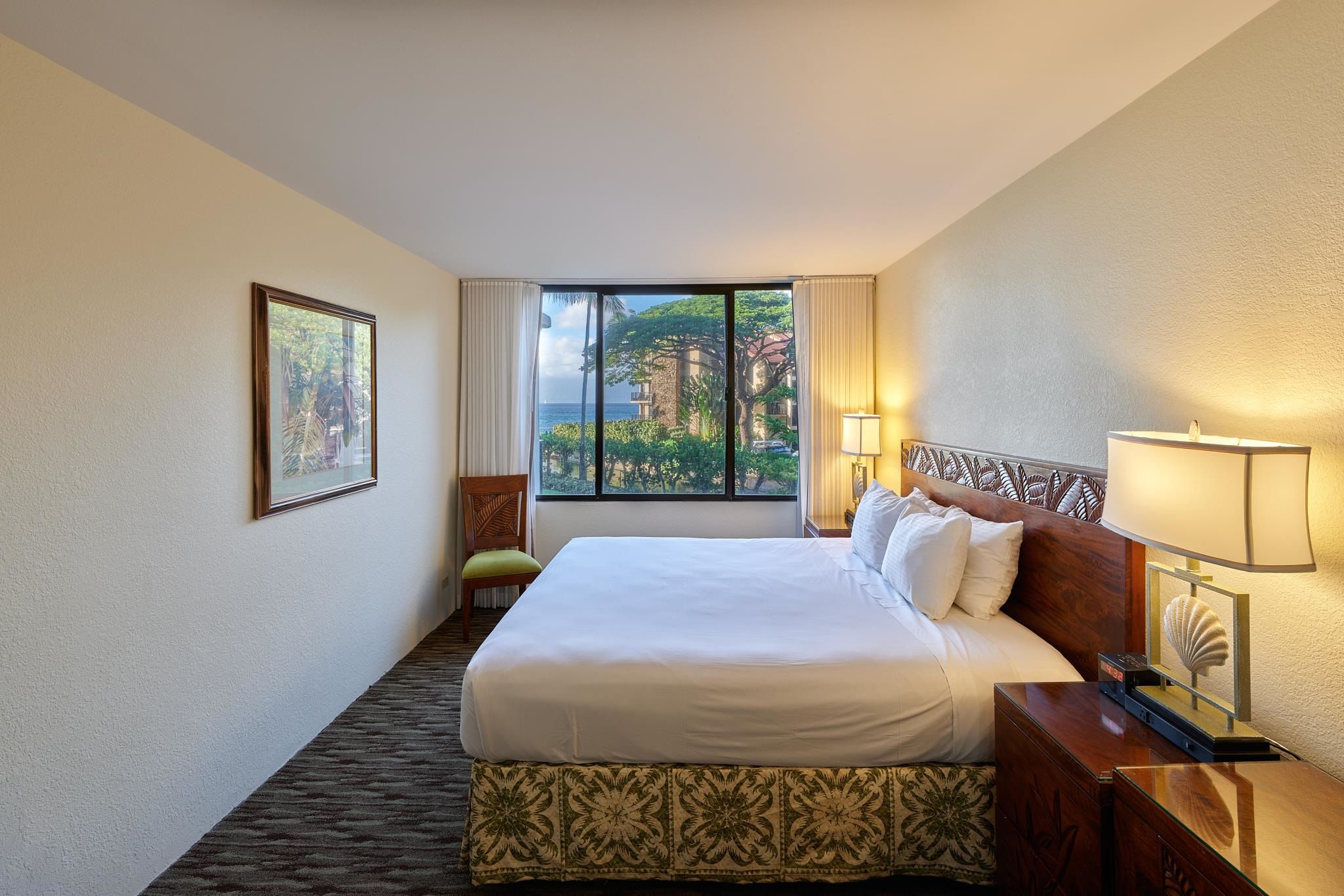 3445 Lower Honoapiilani Road, Unit 212 Lahaina, HI 96761 - Photo 28 of 39 a bed sitting in a bedroom next to a window