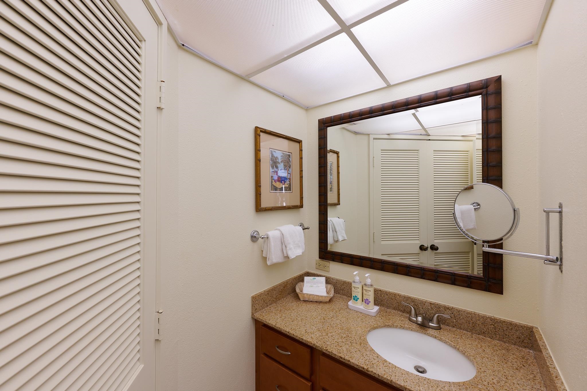 3445 Lower Honoapiilani Road, Unit 212 Lahaina, HI 96761 - Photo 31 of 39 a bathroom with a granite countertop sink and a mirror