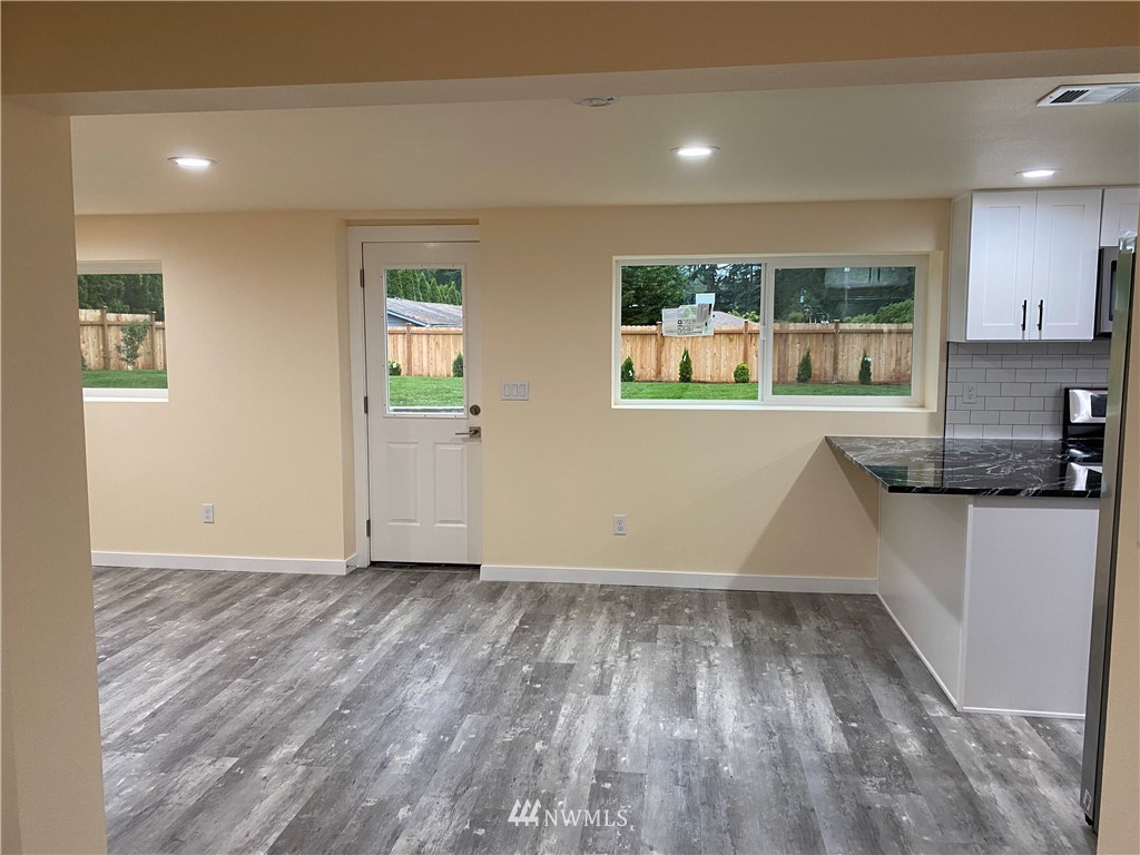 17326 North Road Bothell, WA 98012 - Photo 14 of 27 a view of a kitchen with wooden floor and a window