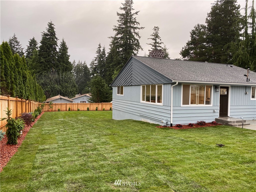 17326 North Road Bothell, WA 98012 - Photo 22 of 27 a front view of a house with a garden