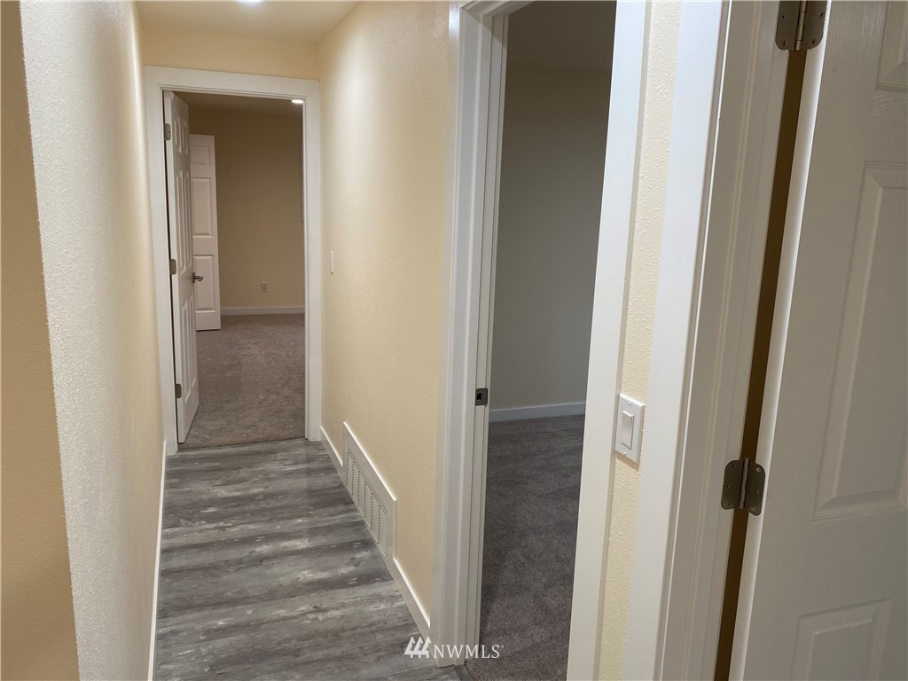 17326 North Road Bothell, WA 98012 - Photo 8 of 27 a view of a hallway with wooden floor