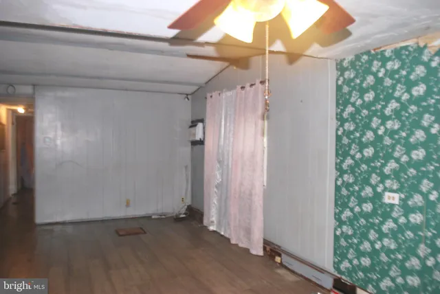 a view of a room with a mirror and furniture