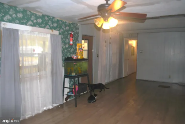 a view of a room with wooden floor
